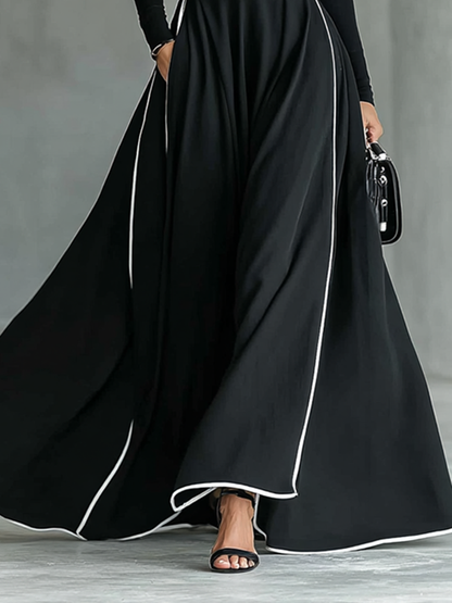 Vestido Maxi Negro con Costuras Blancas, Cuello Alto, Manga Larga y Cintura Entallada